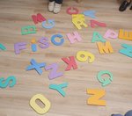 Buchstaben zum gemeinsamen Spielen liegen auf dem Boden